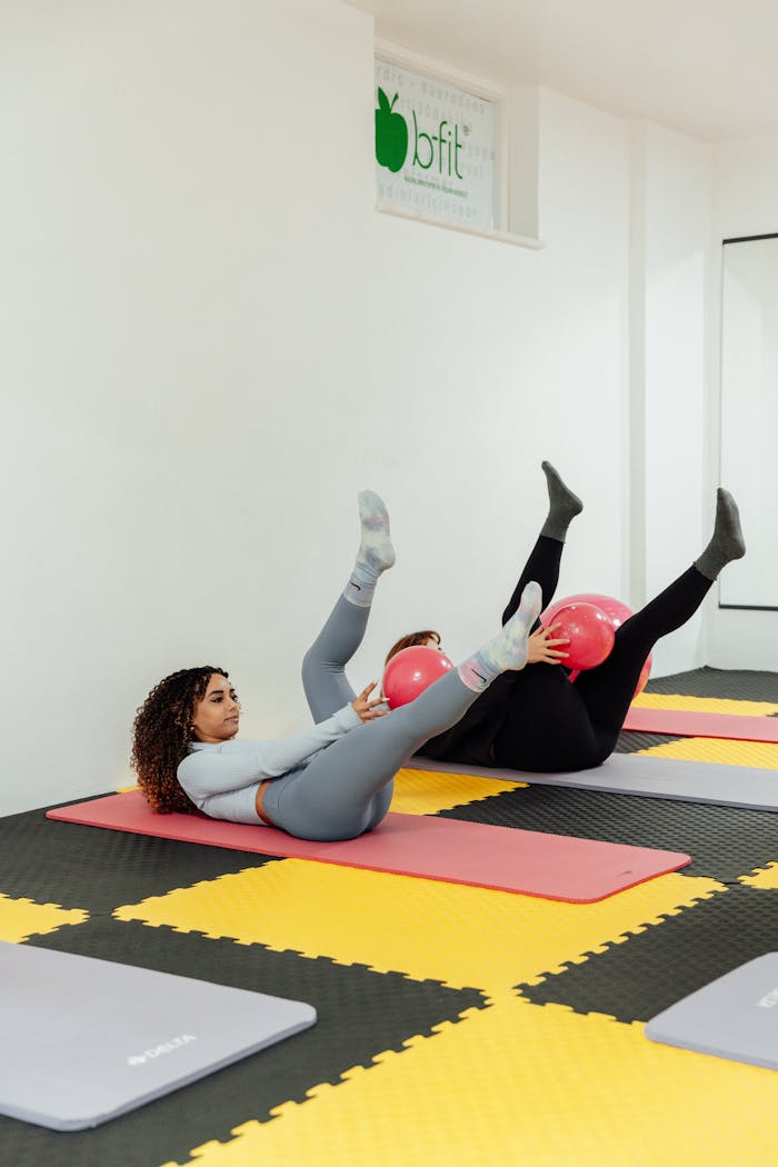 Women working out with exercise balls on gym mats in a fitness studio, Yalova, Türkiye.